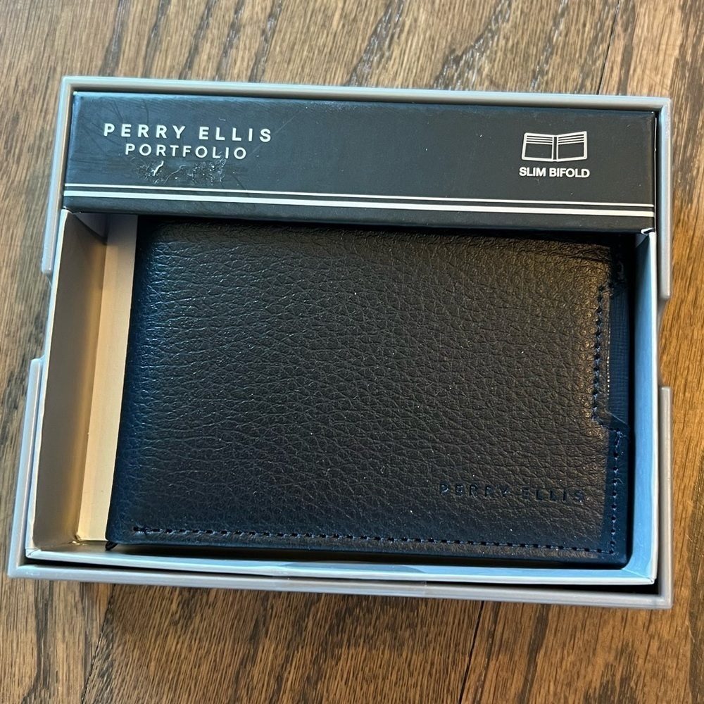 NWT Perry Ellis navy slim bifold leather wallet in box.
